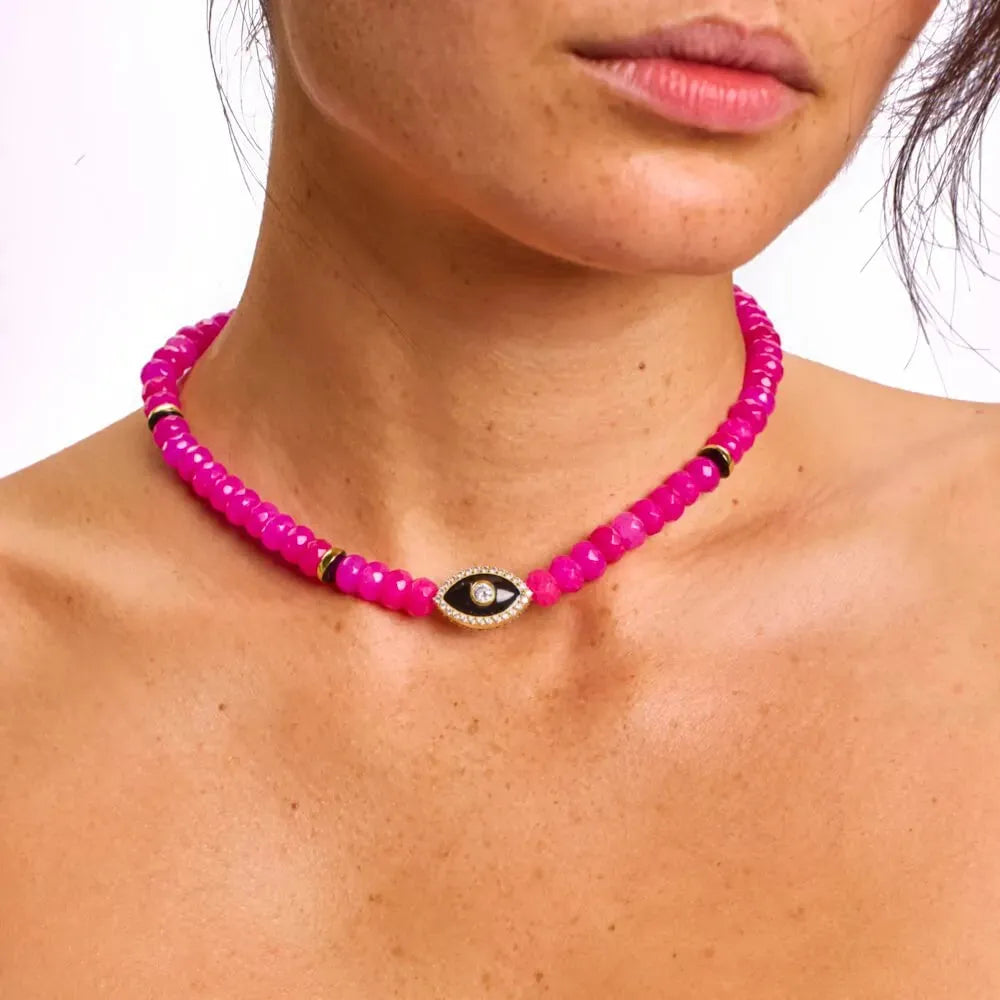 Model wearing the Stella pink necklace, showcasing its vivid beads and the evil eye charm for a unique blend of energy protection and chic fashion.