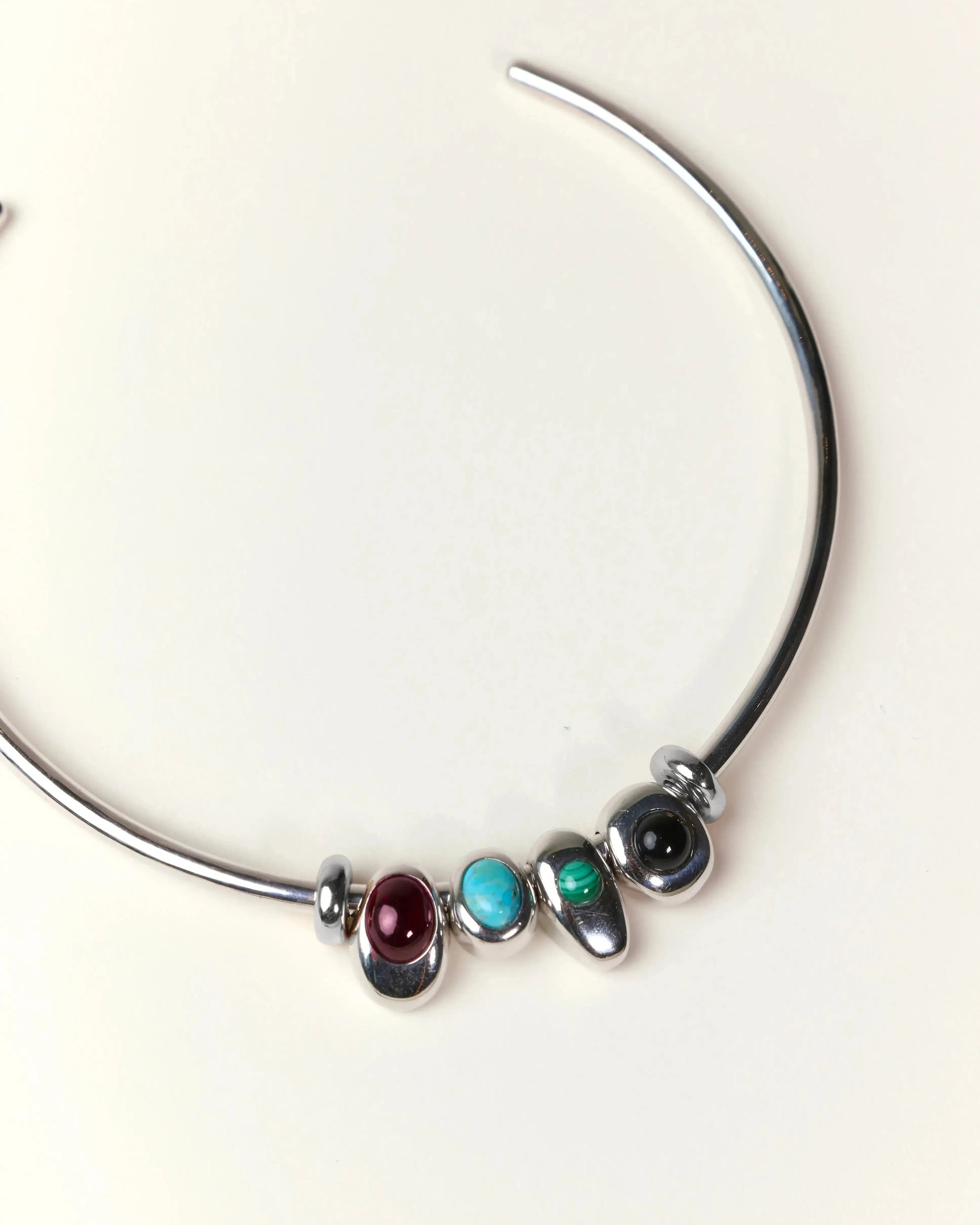 Terre necklace styled with all four interchangeable gemstone charms representing the elements of fire, water, earth, and air.