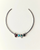 Silver necklace with colored beads on a light beige background