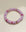 Close-up view of a single valerie lavender bracelet from the set of three, highlighting its soft purple beads with pink and gold dividers arranged in a circular layout.