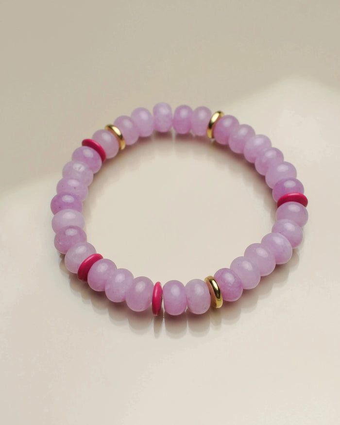 Close-up view of a single valerie lavender bracelet from the set of three, highlighting its soft purple beads with pink and gold dividers arranged in a circular layout.