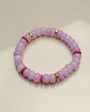 Close-up view of a single valerie lavender bracelet from the set of three, highlighting its soft purple beads with pink and gold dividers arranged in a circular layout.